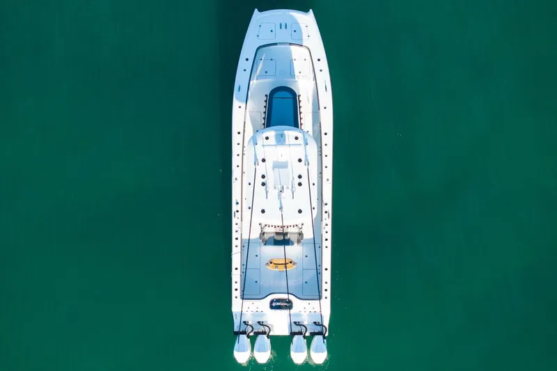 Full Send Yacht Photos Pics Aerial view of 2024 Freeman 38 boat on clear green water.