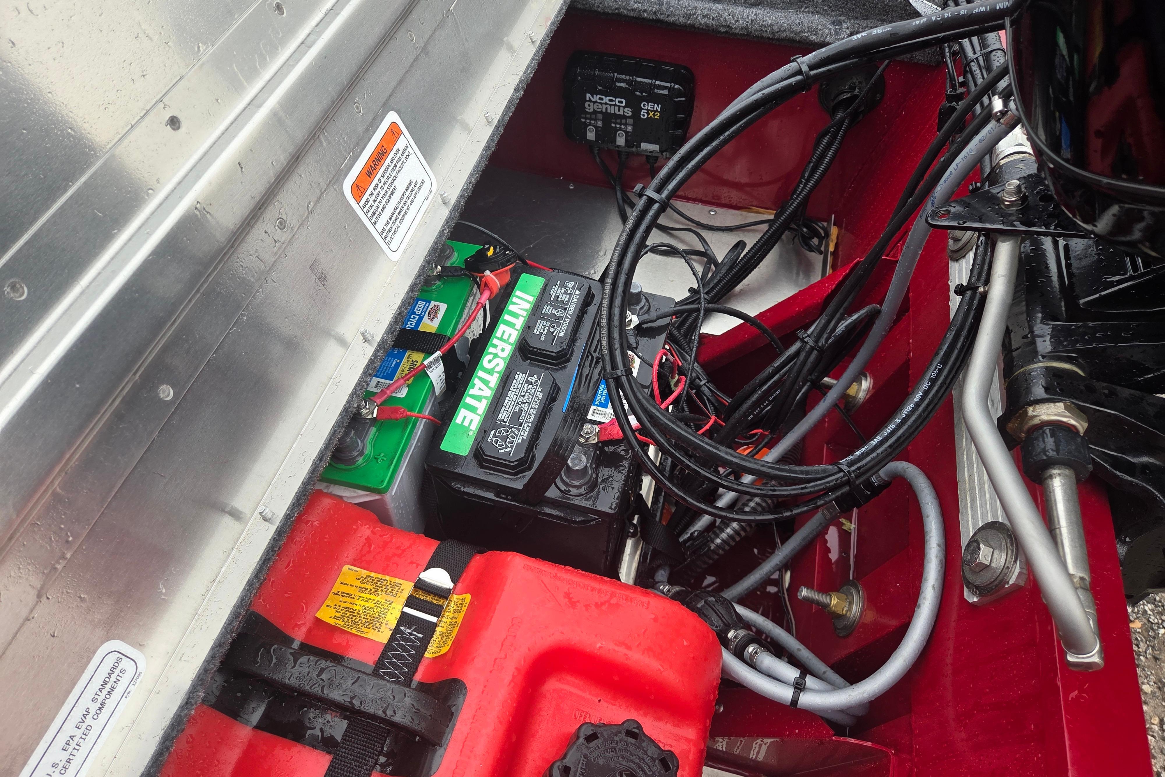 2025 Tracker Super Guide V-16 SC boat battery compartment with wiring and Interstate battery.