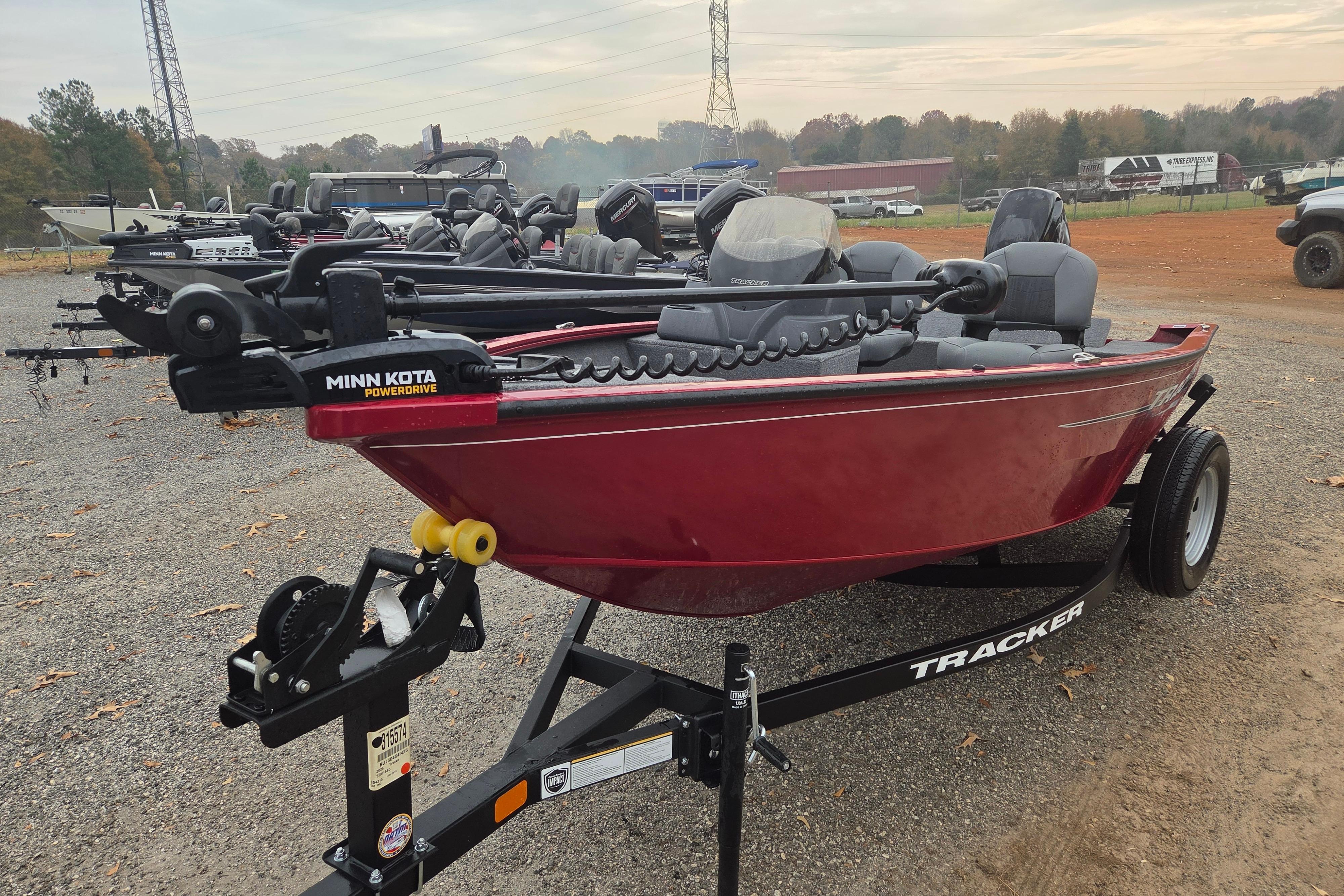 2025 Tracker Super Guide V-16 SC boat with Minn Kota PowerDrive, parked on gravel.
