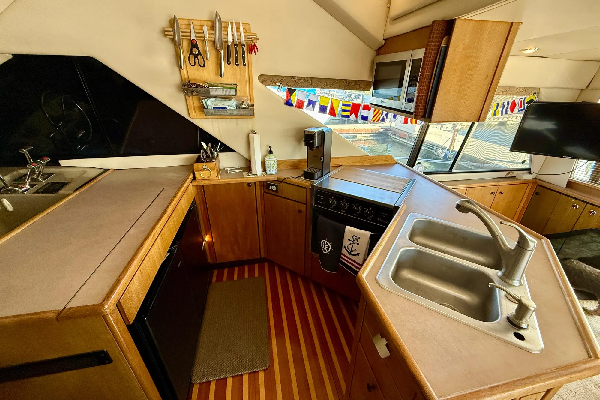 1998 Bayliner 3988 Command Bridge Motoryacht kitchen with sink, stove, and nautical decor.