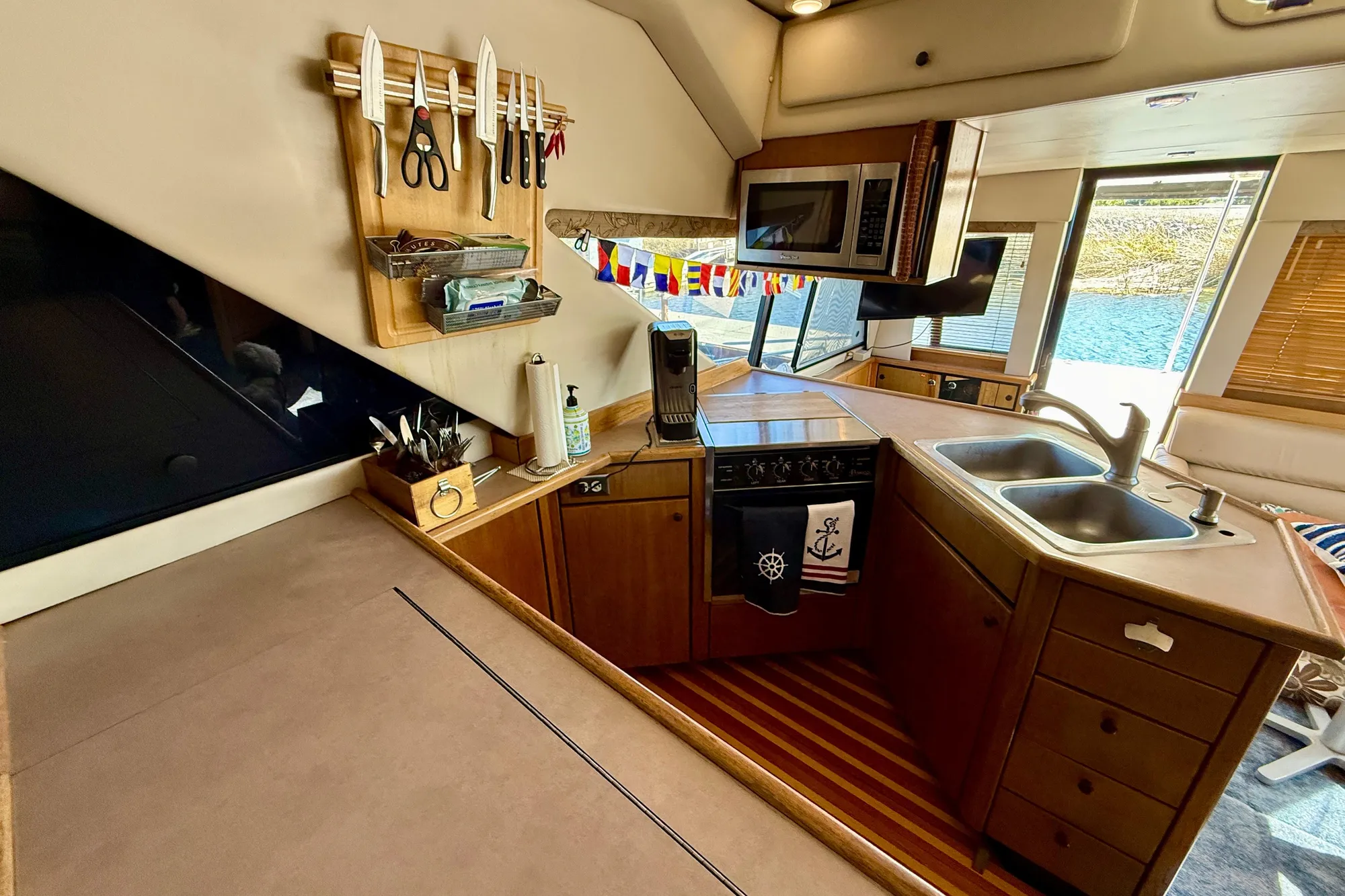 1998 Bayliner 3988 Command Bridge Motoryacht kitchen with wooden cabinetry and dual sinks.
