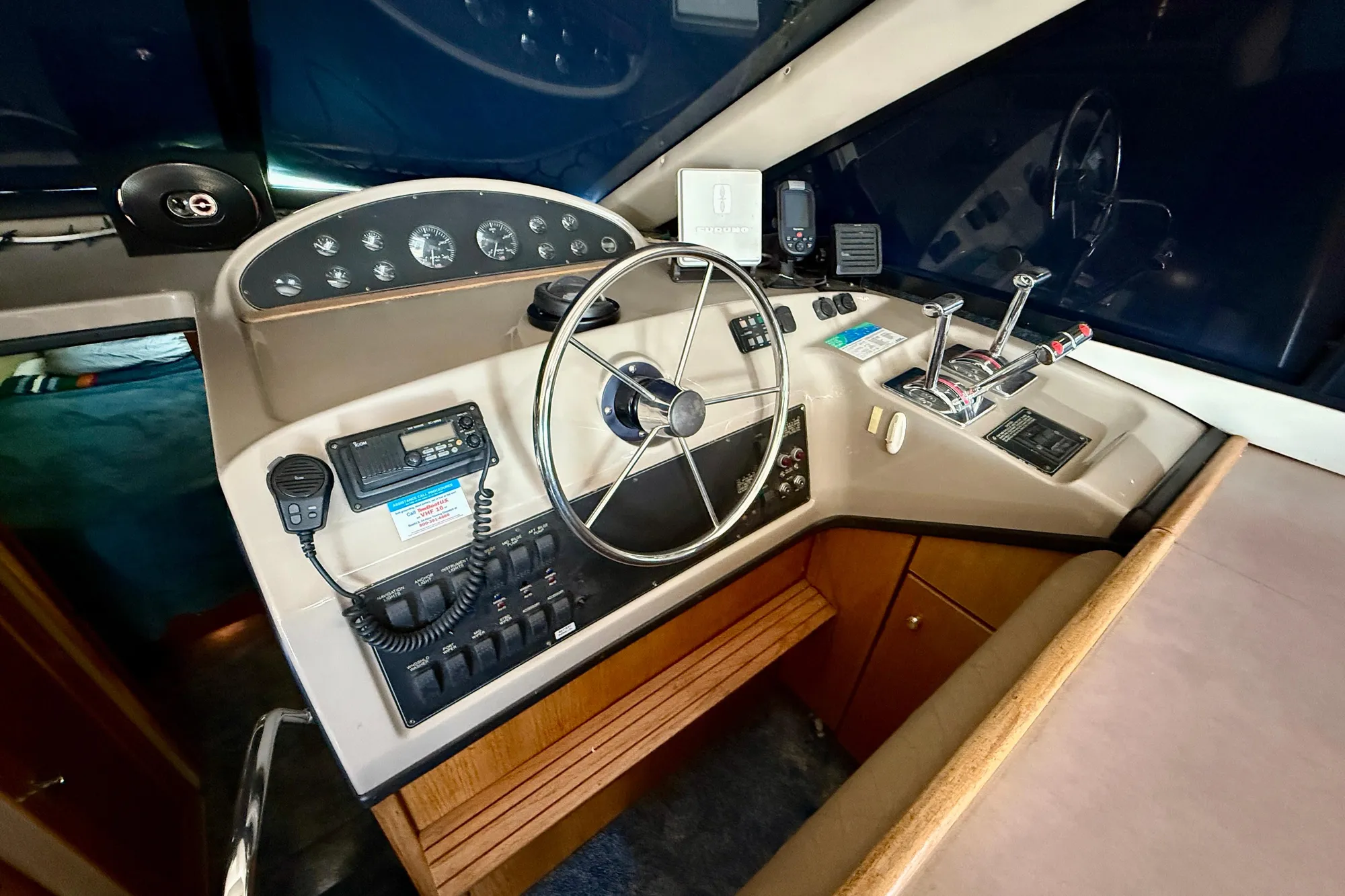 1998 Bayliner 3988 Command Bridge Motoryacht helm with steering wheel and control panel.