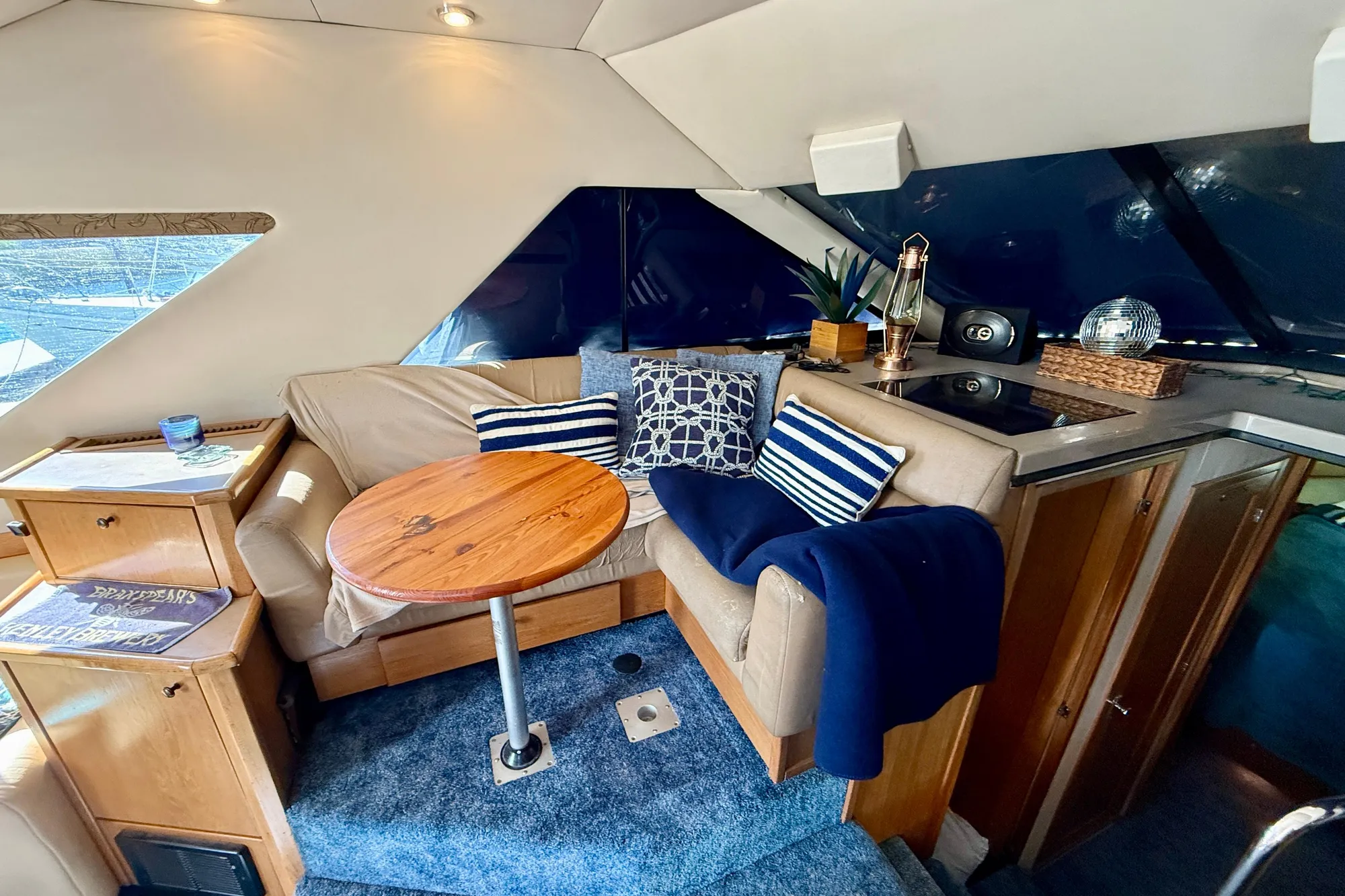 1998 Bayliner 3988 Command Bridge Motoryacht interior with cozy seating and wooden table.