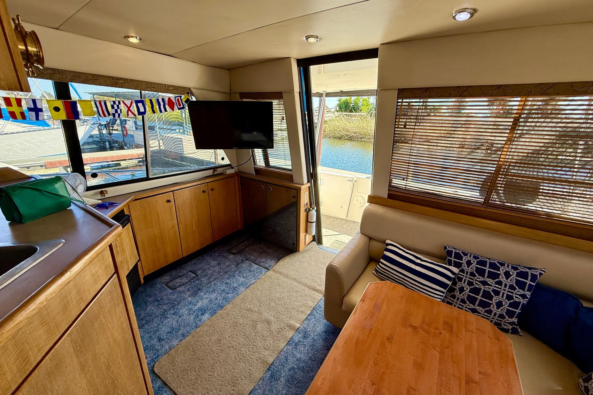 Interior of 1998 Bayliner 3988 Command Bridge Motoryacht with cozy seating and nautical decor.