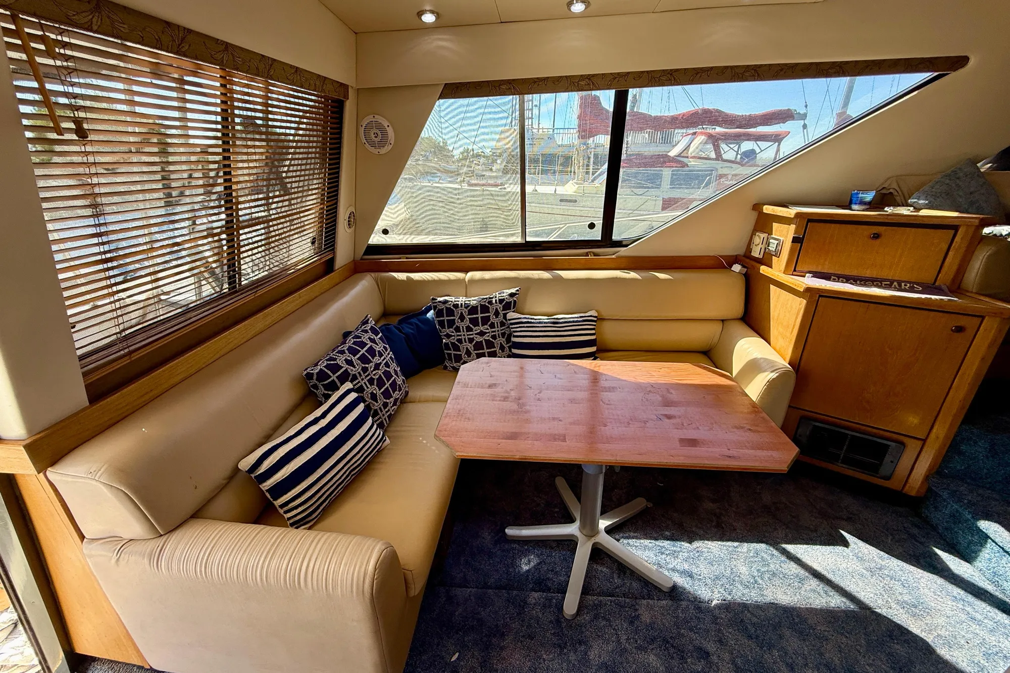 1998 Bayliner 3988 Command Bridge Motoryacht interior with cozy seating and wooden table.
