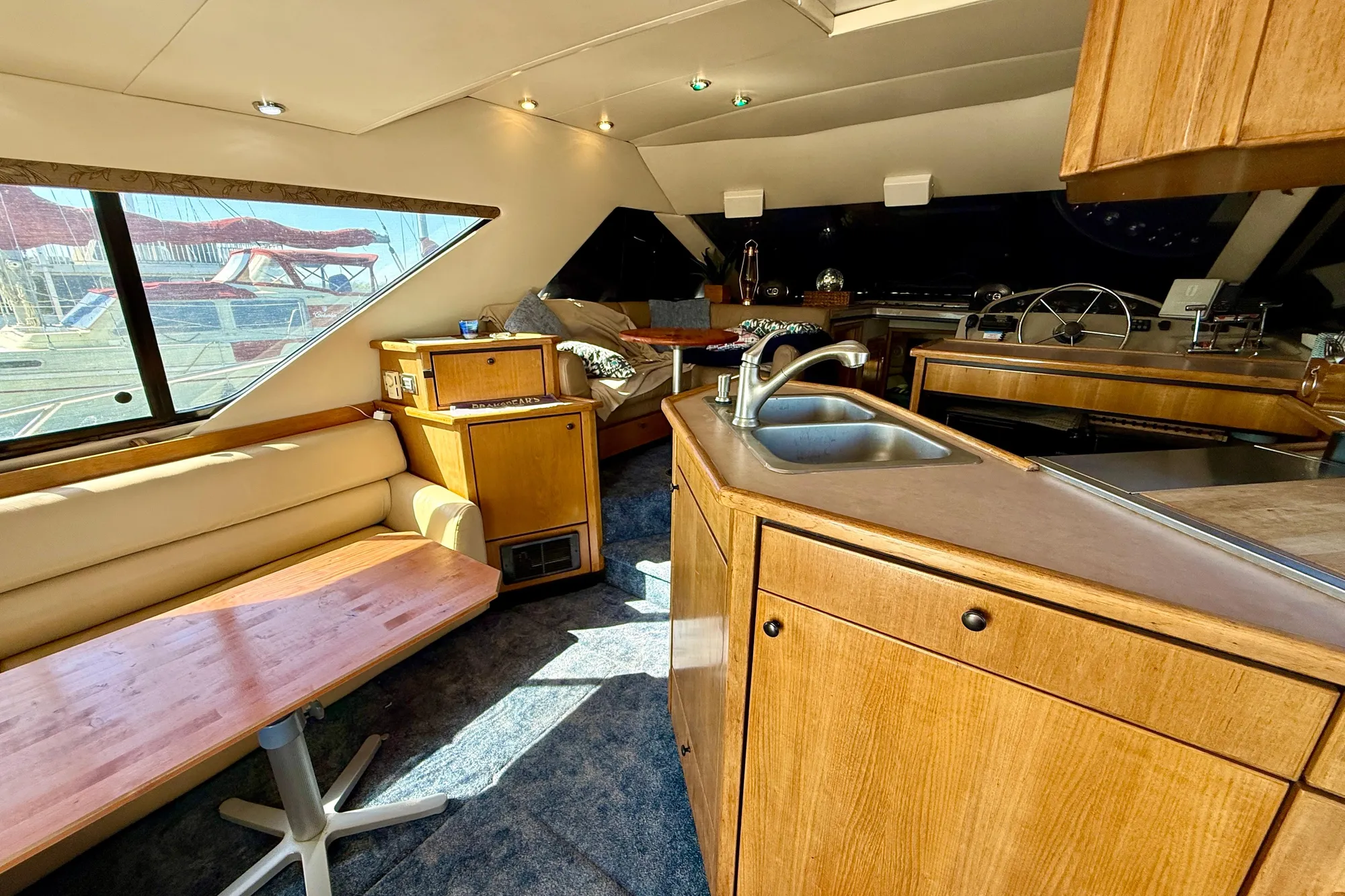 Interior of 1998 Bayliner 3988 Command Bridge Motoryacht with wood cabinetry and seating area.