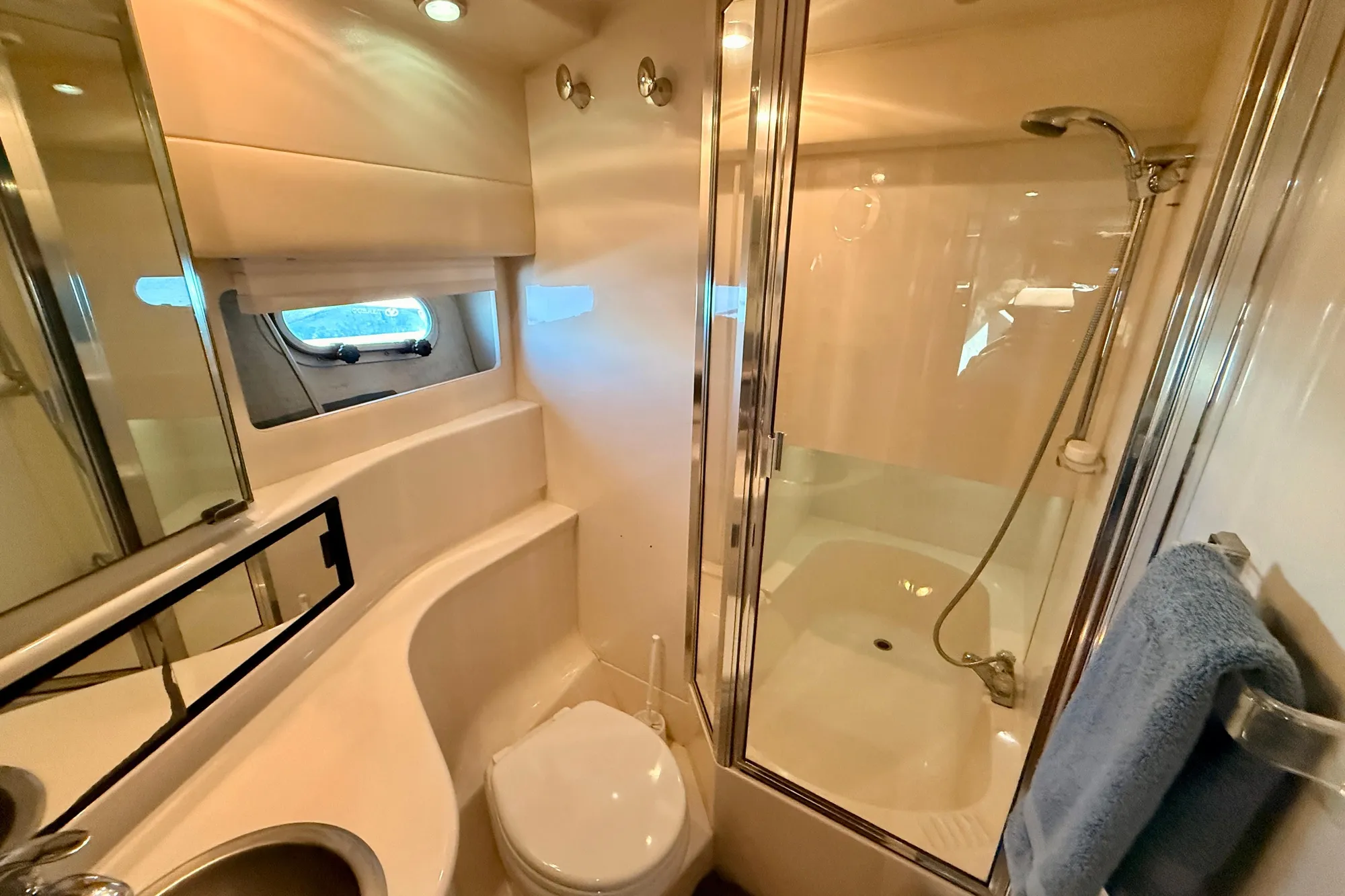 Bathroom of 1998 Bayliner 3988 Command Bridge Motoryacht with shower and porthole window.