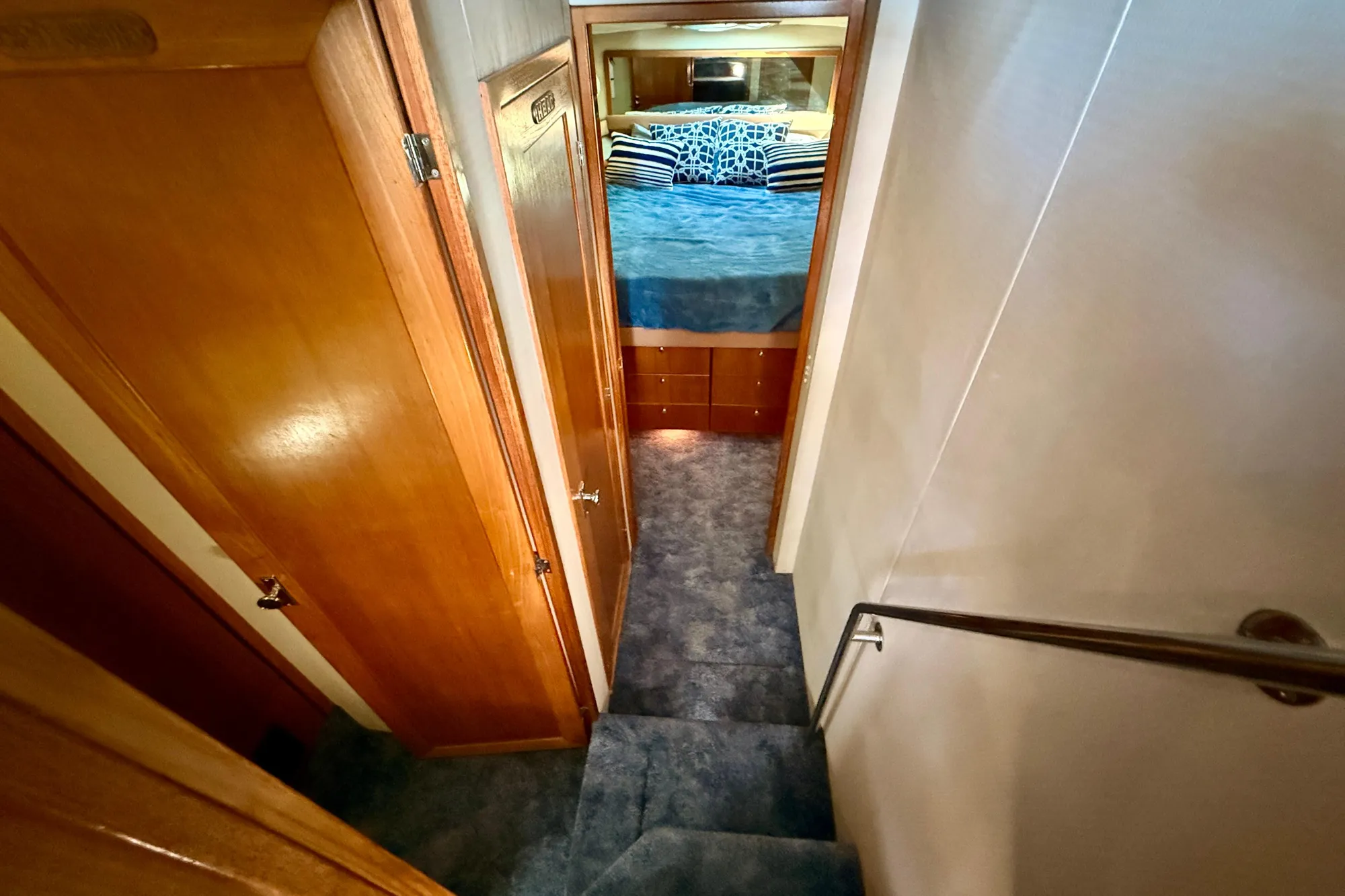 1998 Bayliner 3988 Command Bridge Motoryacht interior with stairs leading to cozy bedroom.