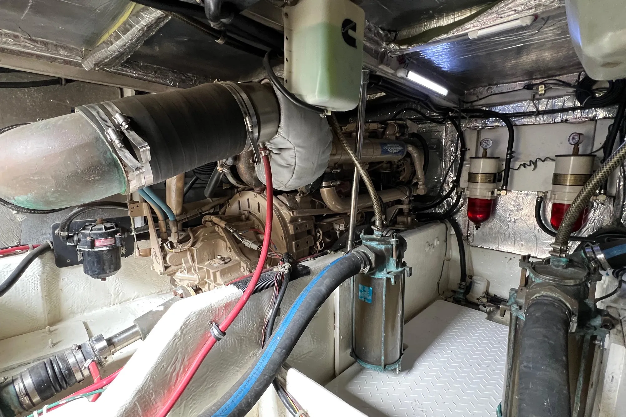 Engine room of 1998 Bayliner 3988 Command Bridge Motoryacht, showcasing mechanical components.