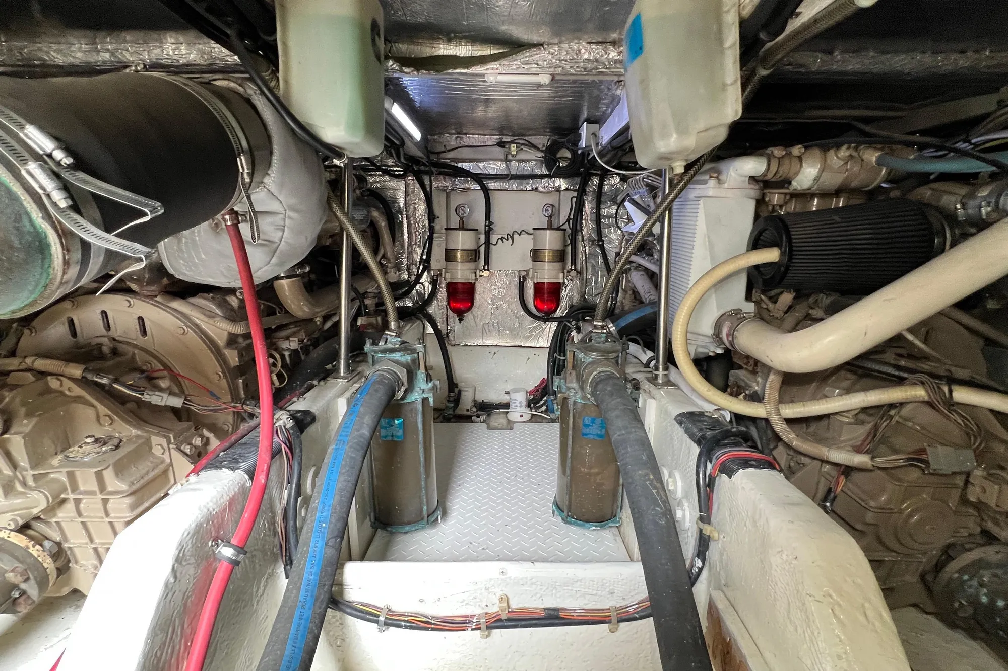 Engine room of 1998 Bayliner 3988 Command Bridge Motoryacht, showcasing mechanical components.