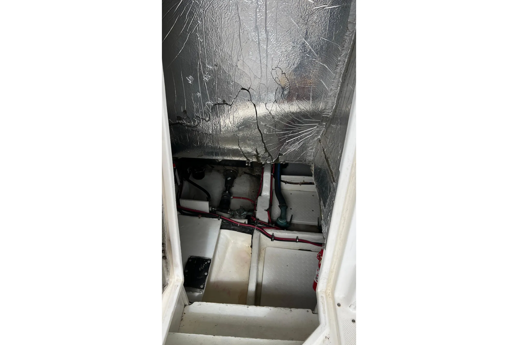 Engine compartment of 1998 Bayliner 3988 Command Bridge Motoryacht with visible insulation and wiring.