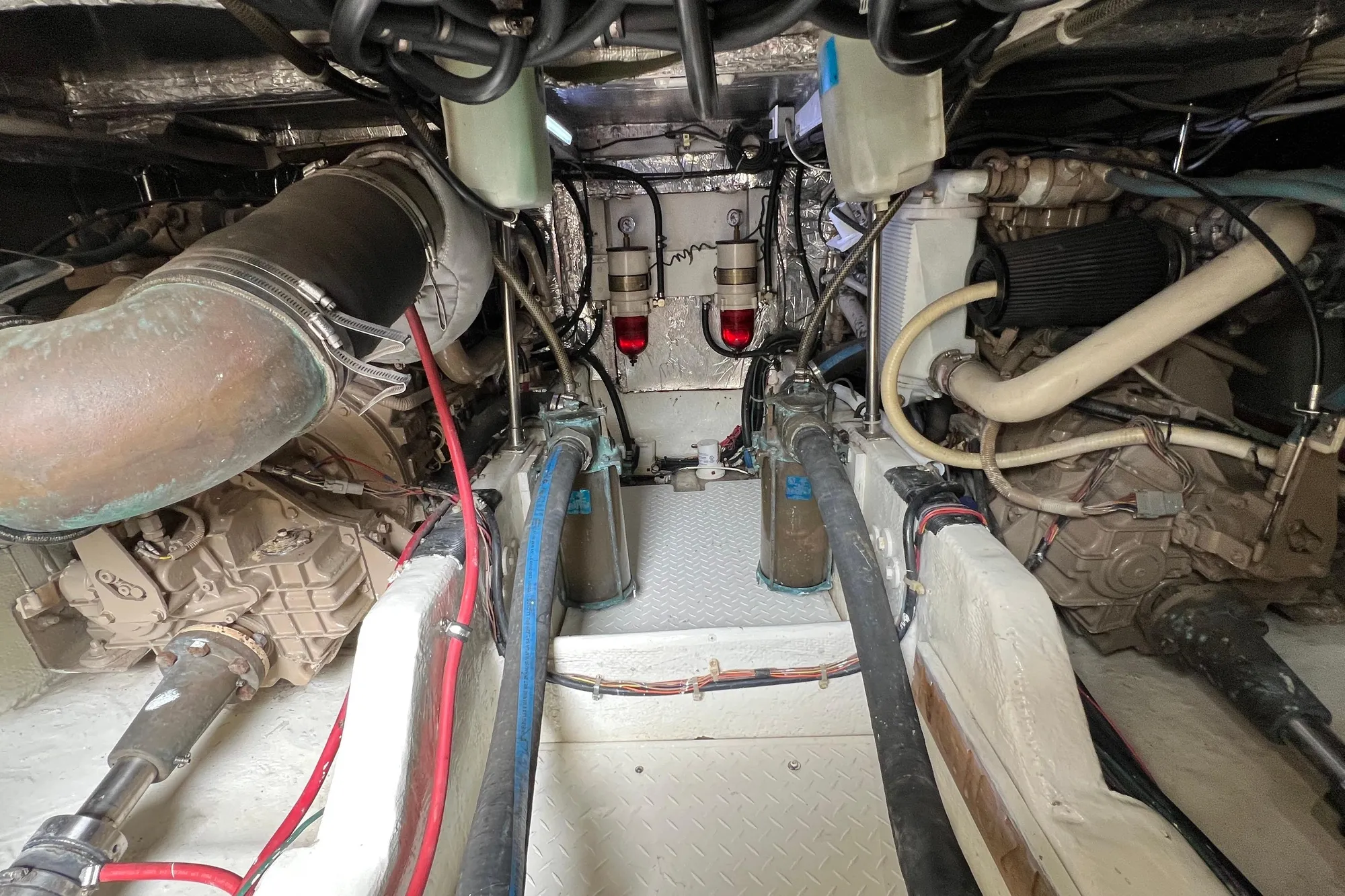 Engine room of 1998 Bayliner 3988 Command Bridge Motoryacht, showcasing mechanical components.