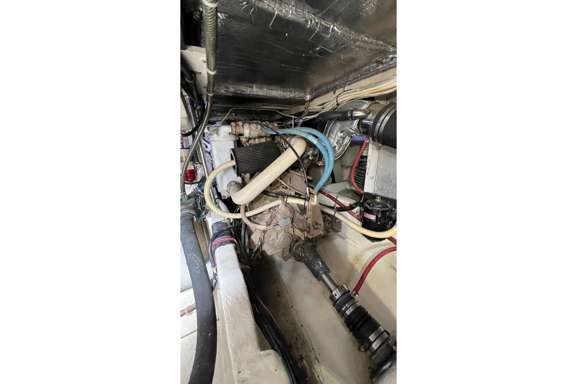 Engine compartment of 1998 Bayliner 3988 Command Bridge Motoryacht, showcasing mechanical components and wiring.