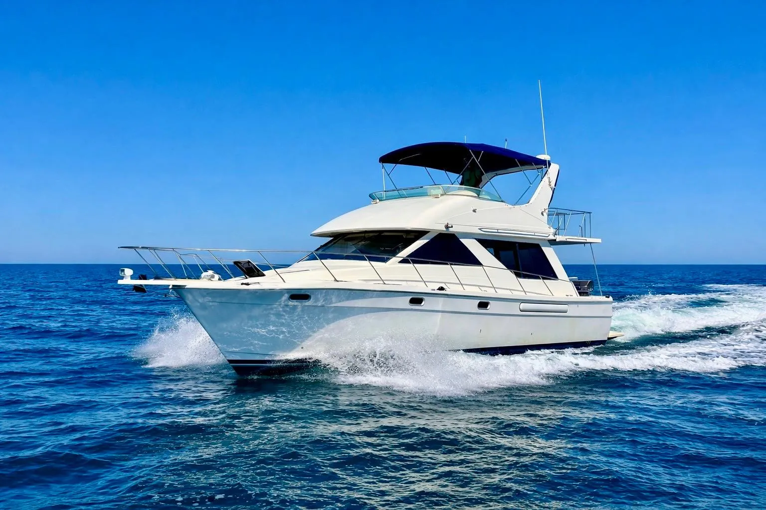 1998 Bayliner 3988 Command Bridge Motoryacht cruising on open blue sea.