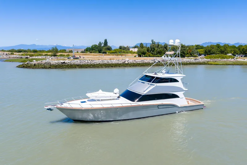  Yacht Photos Pics 1998 Donzi R73 yacht cruising on a calm river with scenic background.