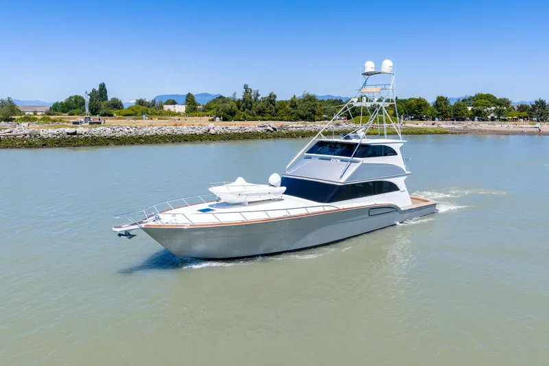  Yacht Photos Pics 1998 Donzi R73 yacht cruising on a calm river with scenic shoreline.