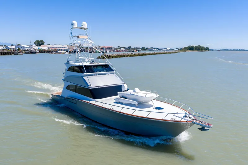  Yacht Photos Pics 1998 Donzi R73 yacht cruising on calm waters under a clear blue sky.
