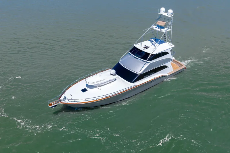  Yacht Photos Pics 1998 Donzi R73 yacht cruising on open water, showcasing sleek design and luxury features.