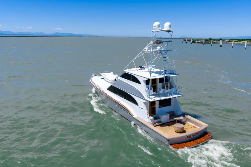  Yacht Photos Pics 1998 Donzi R73 yacht cruising on open water under clear blue skies.