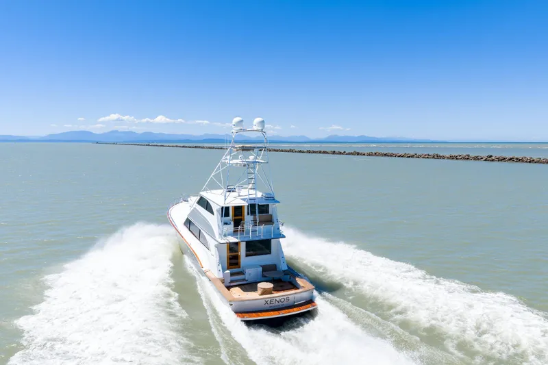  Yacht Photos Pics 1998 Donzi R73 yacht cruising on open water under clear blue skies.