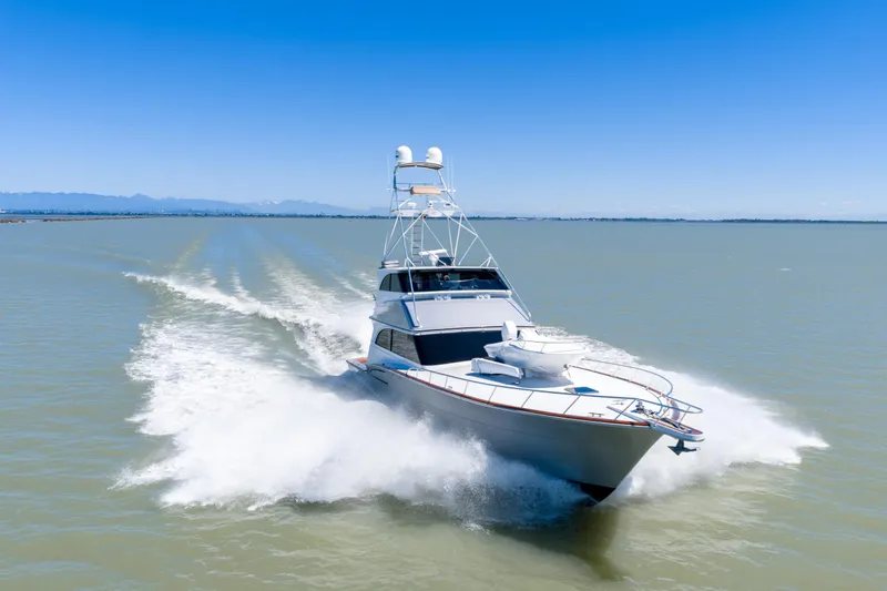  Yacht Photos Pics 1998 Donzi R73 yacht cruising on open water under clear blue skies.