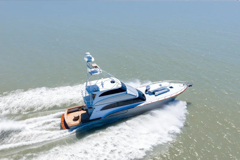  Yacht Photos Pics 1998 Donzi R73 yacht cruising on open water, showcasing sleek design and powerful performance.