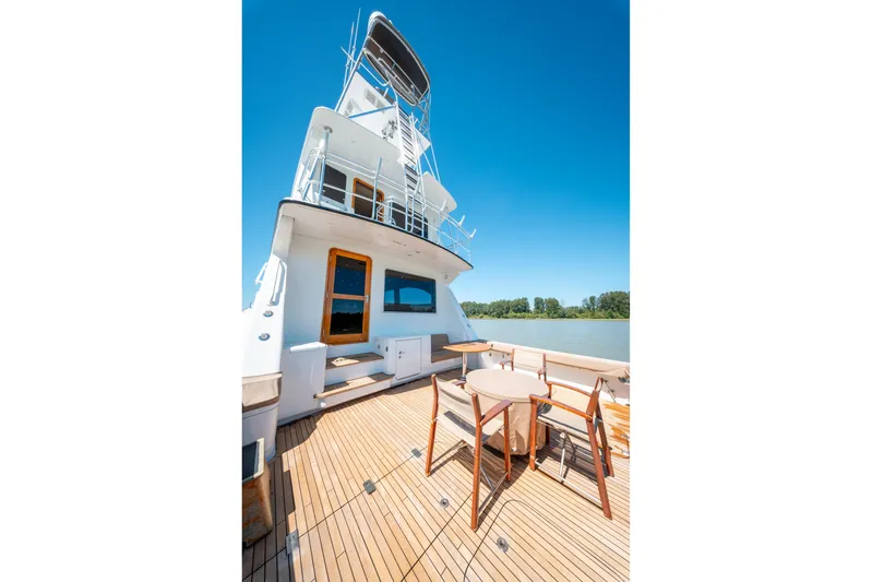  Yacht Photos Pics 1998 Donzi R73 yacht deck with seating, wooden flooring, and clear blue sky.