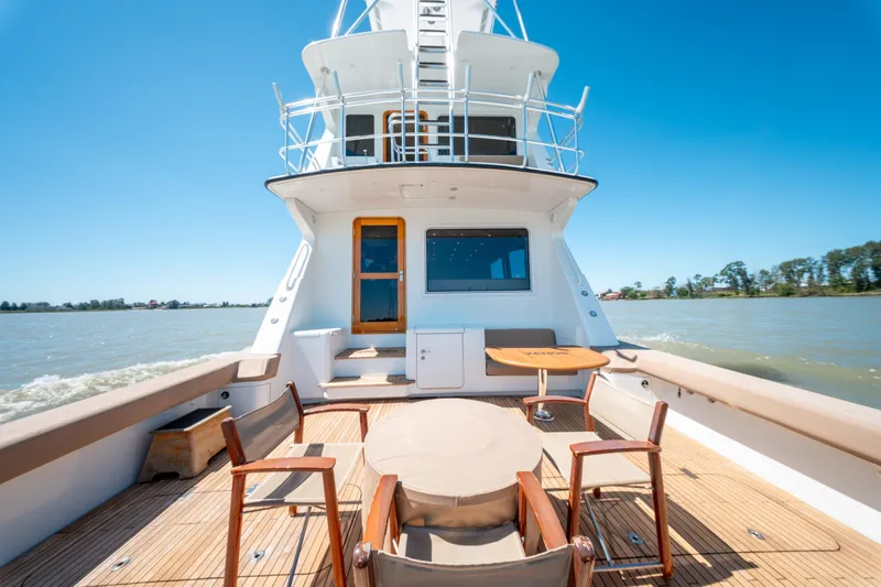  Yacht Photos Pics 1998 Donzi R73 yacht deck with seating, cruising on a sunny day.