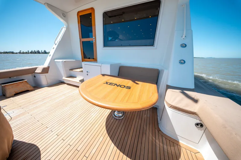  Yacht Photos Pics 1998 Donzi R73 yacht deck with wooden table and seating, ocean view.