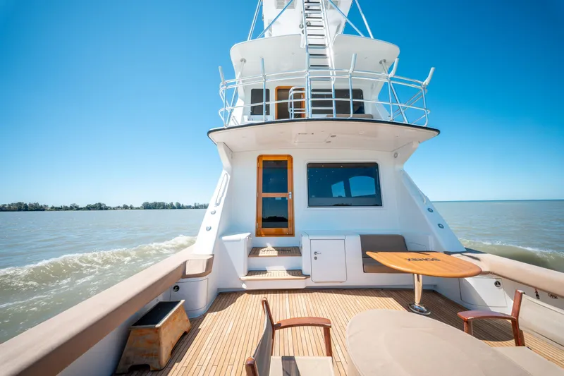  Yacht Photos Pics 1998 Donzi R73 yacht deck with seating, cruising on a sunny day.