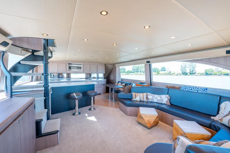  Yacht Photos Pics Luxurious interior of 1998 Donzi R73 yacht with modern seating and spiral staircase.