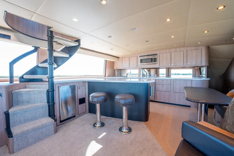 Yacht Photos Pics Luxurious interior of a 1998 Donzi R73 yacht with modern kitchen and spiral staircase.
