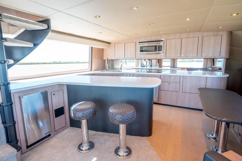  Yacht Photos Pics Luxurious interior of a 1998 Donzi R73 yacht with modern kitchen and seating area.