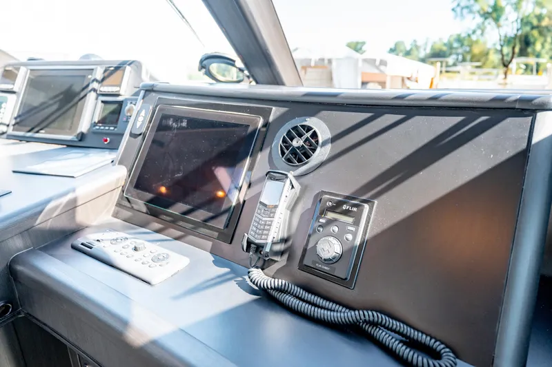  Yacht Photos Pics Control panel of a 1998 Donzi R73 boat with navigation equipment and remote.