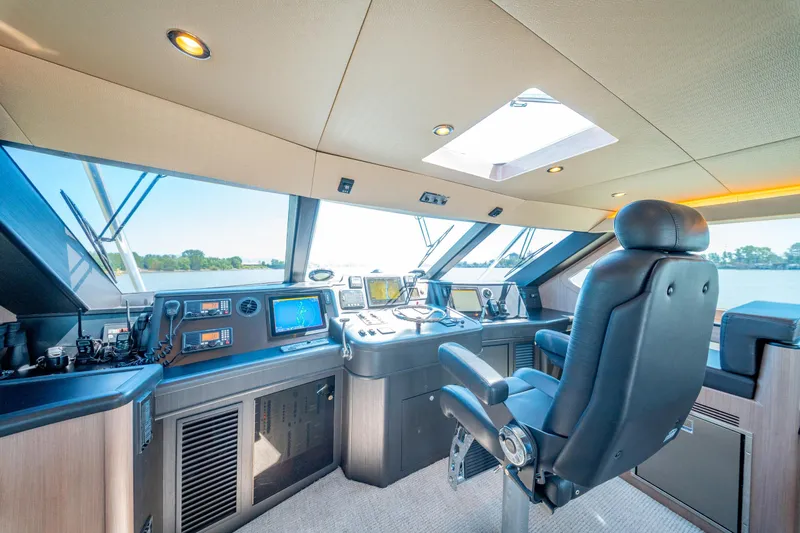  Yacht Photos Pics Cockpit of 1998 Donzi R73 yacht with navigation equipment and captain's chair.