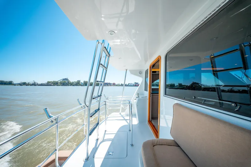  Yacht Photos Pics 1998 Donzi R73 yacht deck with seating, ladder, and scenic water view.