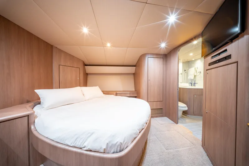  Yacht Photos Pics Luxurious bedroom interior of 1998 Donzi R73 yacht with modern amenities.