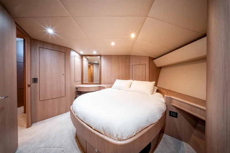  Yacht Photos Pics Luxurious bedroom interior of 1998 Donzi R73 yacht with elegant wood finish.