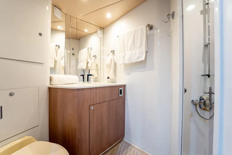  Yacht Photos Pics Luxurious bathroom interior of 1998 Donzi R73 yacht with modern fixtures and wooden cabinetry.