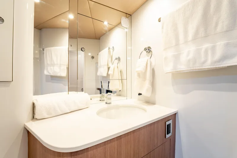  Yacht Photos Pics Luxurious bathroom in 1998 Donzi R73 yacht with modern fixtures and elegant design.