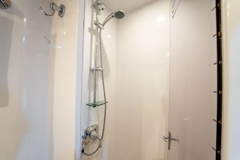  Yacht Photos Pics Shower area inside 1998 Donzi R73 yacht, featuring modern fixtures and glass door.