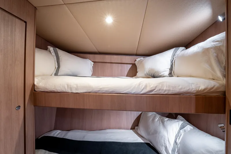  Yacht Photos Pics Cozy bunk beds in 1998 Donzi R73 yacht cabin, featuring elegant wood paneling.