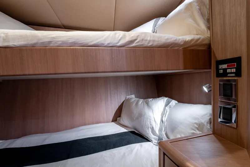  Yacht Photos Pics 1998 Donzi R73 yacht interior with cozy wooden bunk beds and modern lighting.