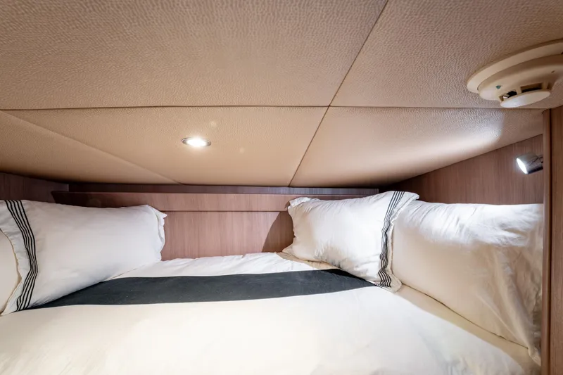  Yacht Photos Pics Cozy cabin bed in 1998 Donzi R73 yacht with soft lighting and plush pillows.
