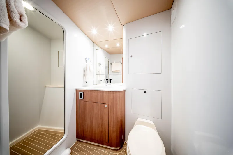 Yacht Photos Pics Luxurious bathroom interior of 1998 Donzi R73 yacht with modern fixtures and wood accents.