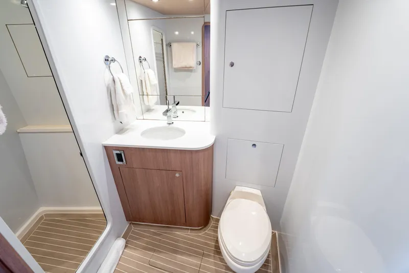  Yacht Photos Pics Luxurious bathroom in 1998 Donzi R73 yacht with modern fixtures and wood accents.