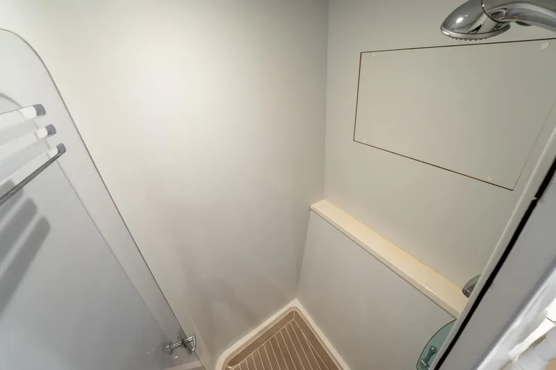  Yacht Photos Pics Shower area in a 1998 Donzi R73 boat, featuring minimalist design and chrome fixtures.