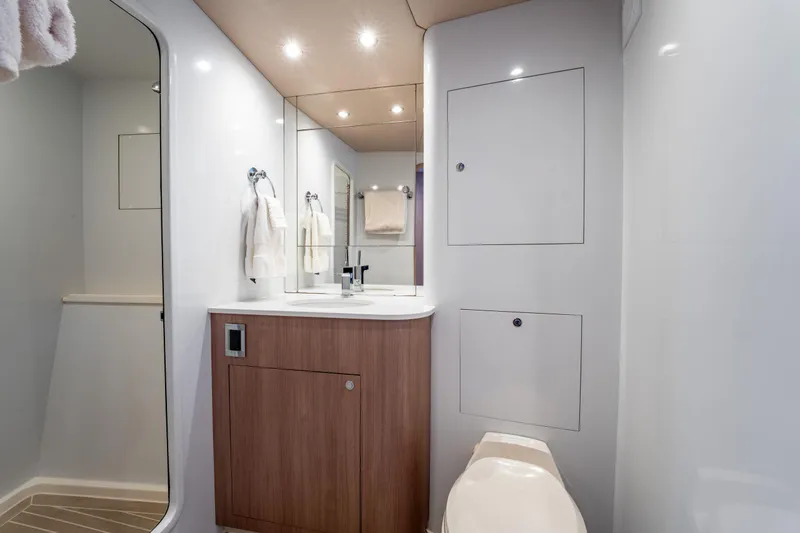  Yacht Photos Pics Luxurious bathroom interior of 1998 Donzi R73 yacht with modern fixtures and wood accents.