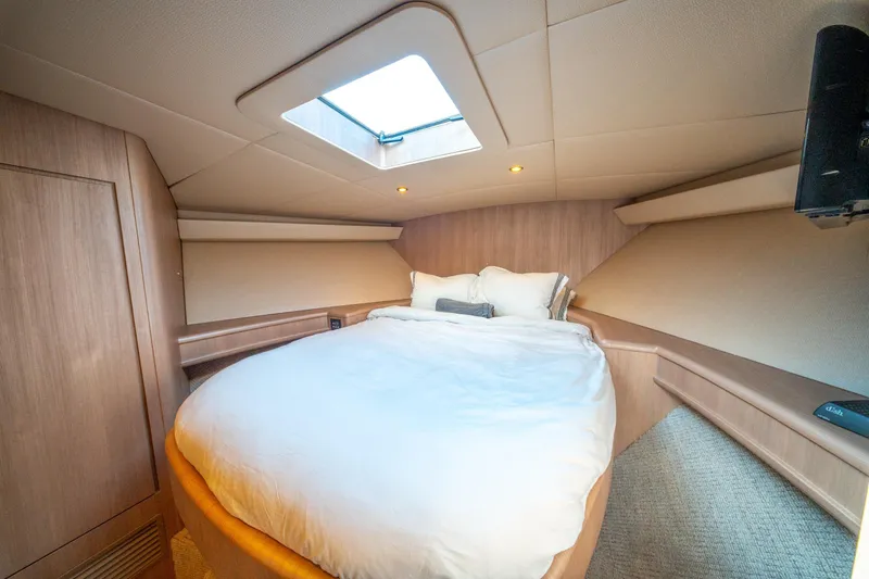  Yacht Photos Pics Luxurious cabin interior of 1998 Donzi R73 yacht with skylight and cozy bedding.