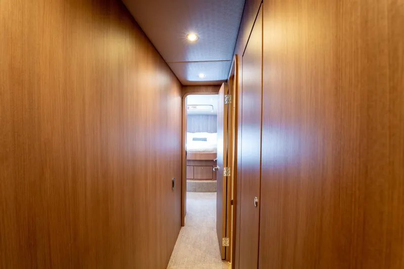  Yacht Photos Pics Interior hallway of 1998 Donzi R73 yacht with wooden paneling and cozy lighting.